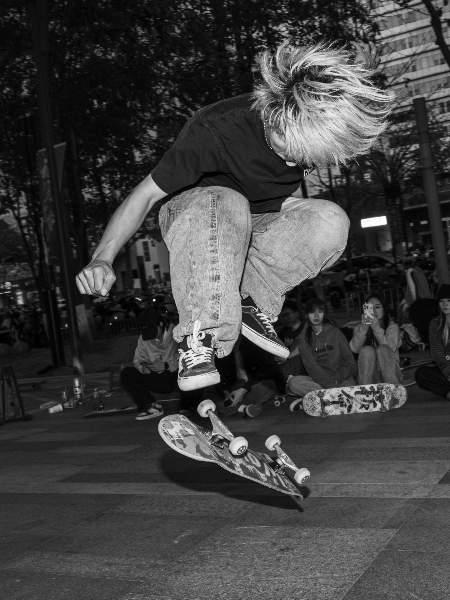 Black and white night session ollie in front of a crowd