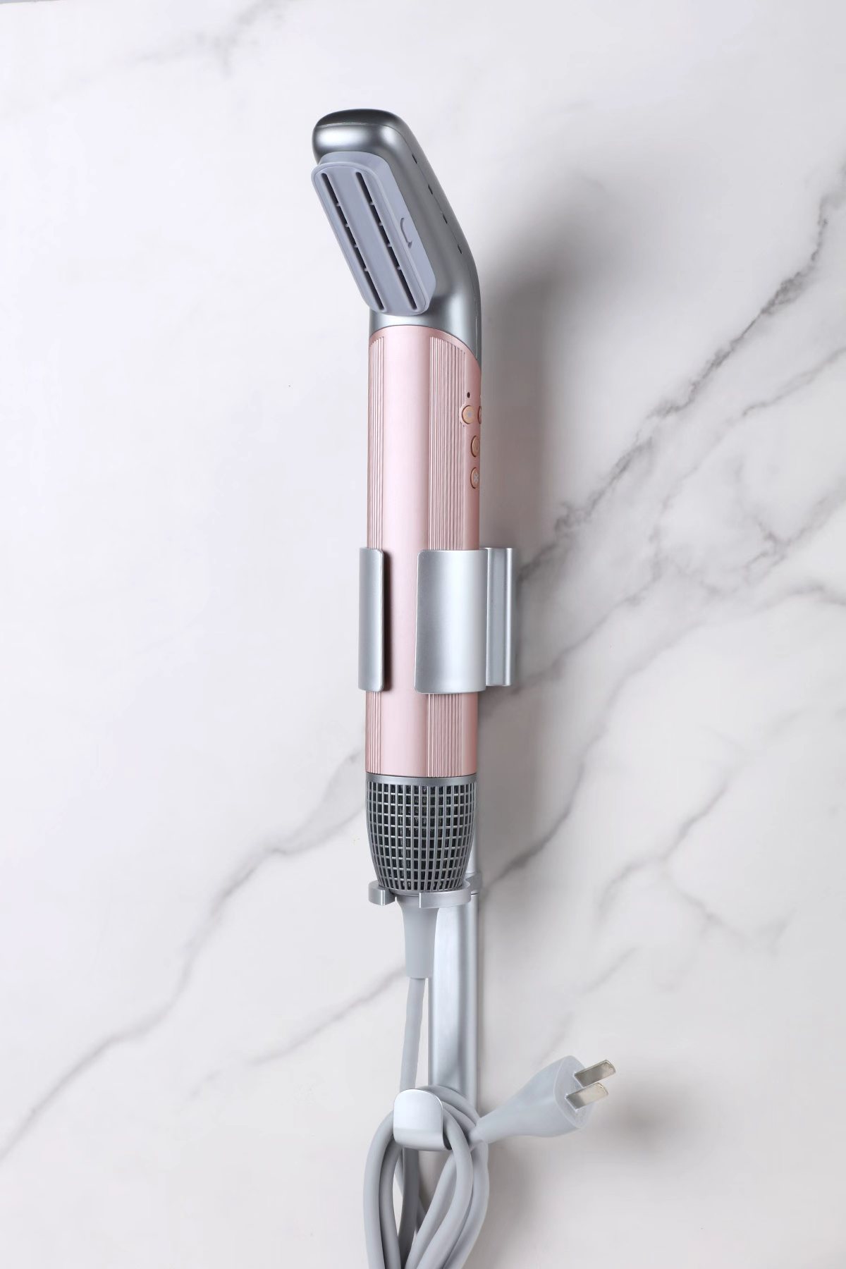 Rose Halo styler resting in its wall bracket on marble