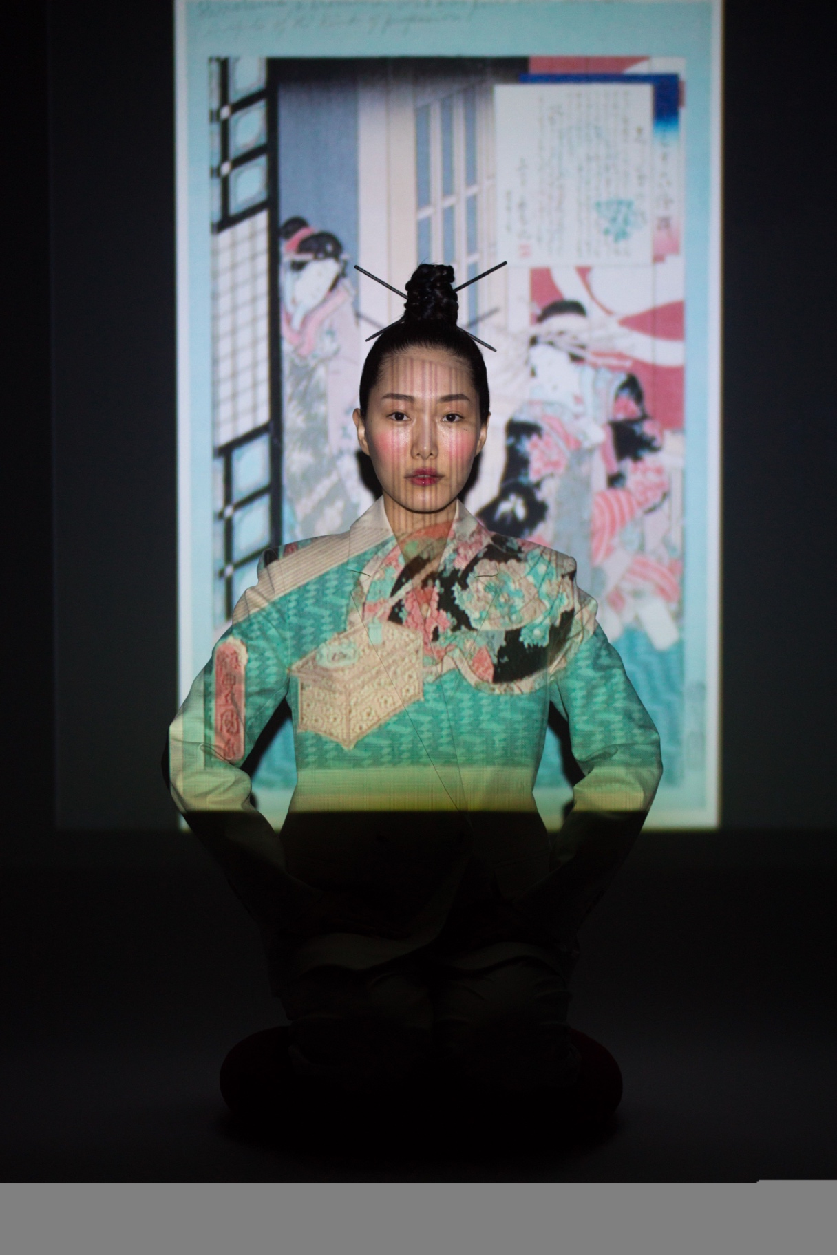 Model seated before a projected ukiyo-e woodblock print