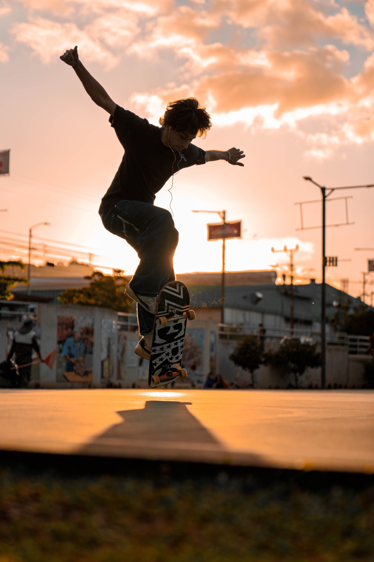 Silhouetted flip trick against a golden sunset